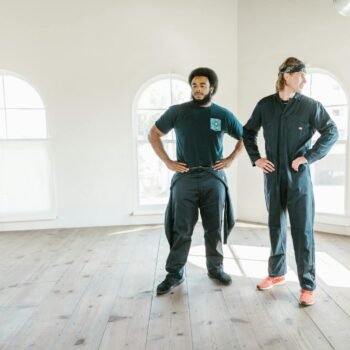 Men Standing Inside an Empty House while Looking Afar
